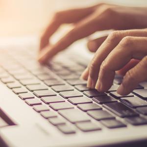 hands typing on a keyboard